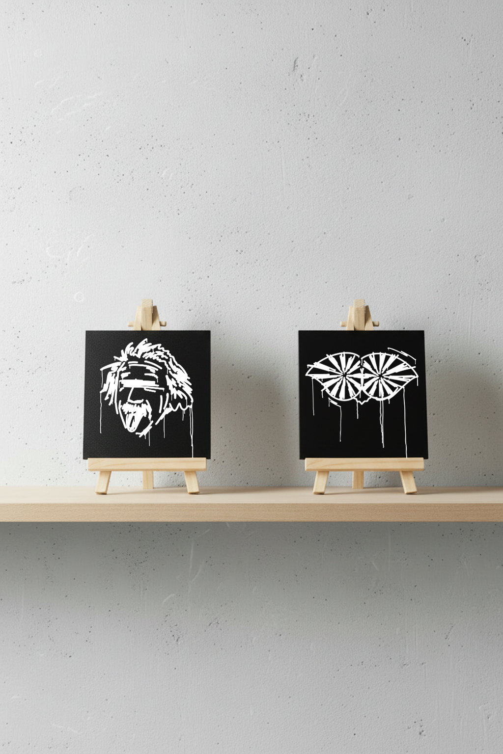 Zwei Designspiegel Mini Schneider von Ulm und Einstein im Urban-Art-Stil nebeneinander auf Regal – moderne Kunstdeko und Geschenkidee